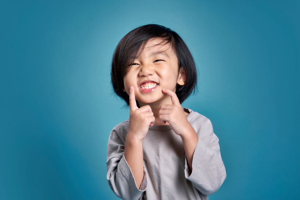 Beautiful,Smiling,Asian,Little,Kid,Show,His,Teeth.,Empty,Space