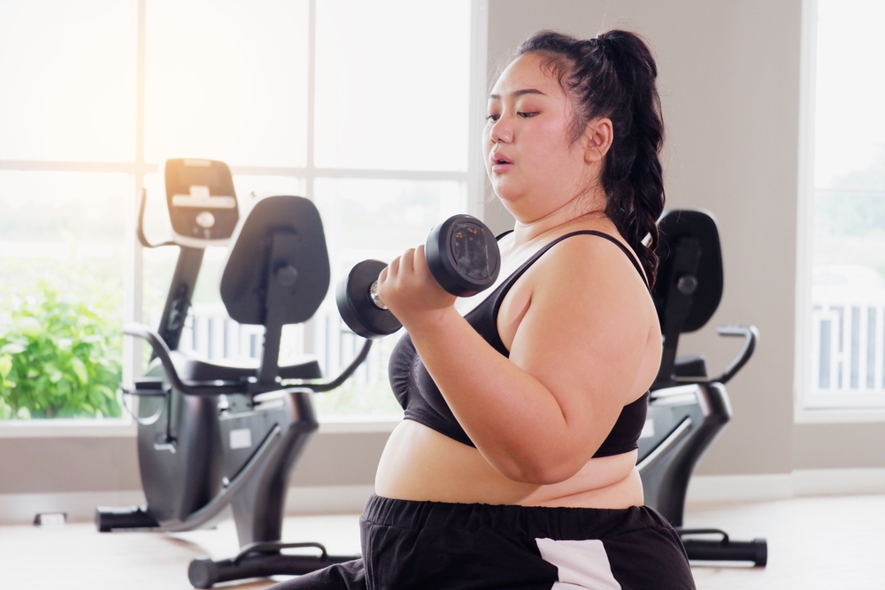 Young,Asian,Woman,Lifting,Dumbbells,Exercising,In,The,Gym.,Exercise